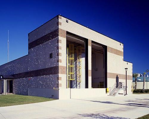 Exterior photo of the brick facility housing vertical tanks.