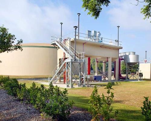 Exterior photo of water storage at the Live Oak Wastewater Treatment Plant. Staircase leads up to platform.